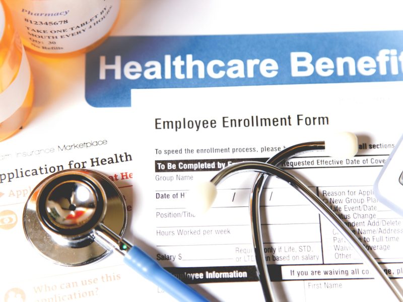 Healthcare benefit forms including: enrollment forms and applications, stethoscope, calculator.  Affordable healthcare remains an important topic around the world!