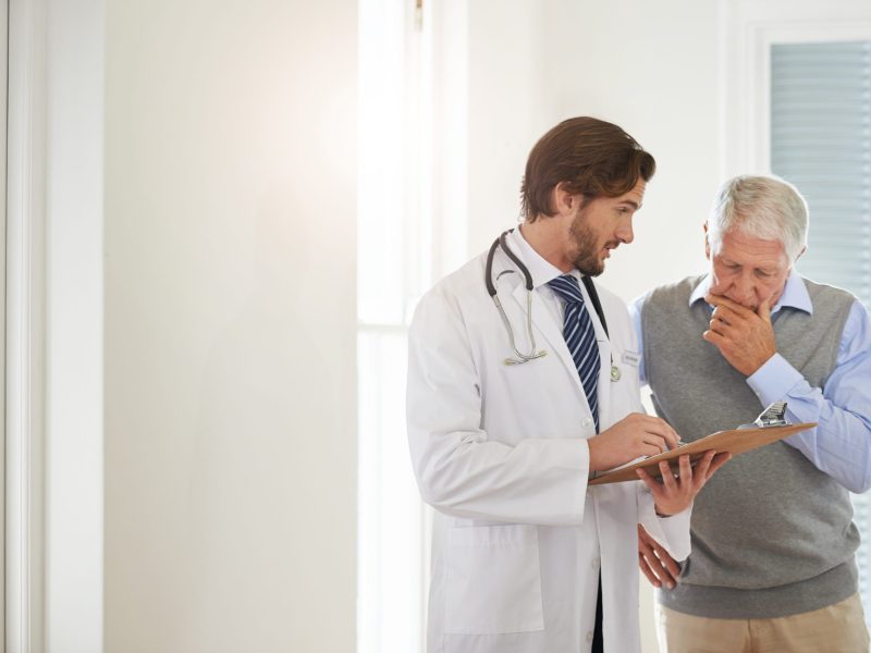 Cropped shot of a doctor talking to a senior patient in a clinic