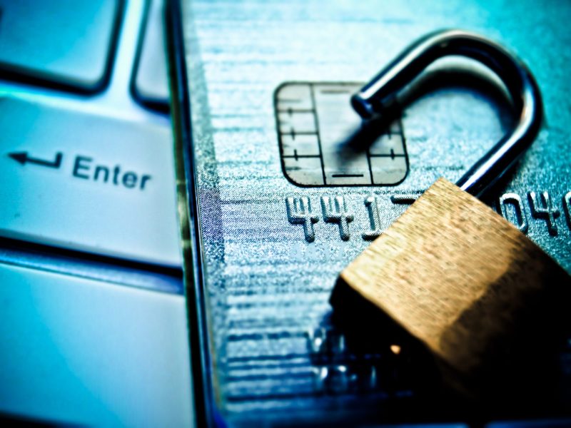 Open security lock on credit cards with computer keyboard / Credit card data breach