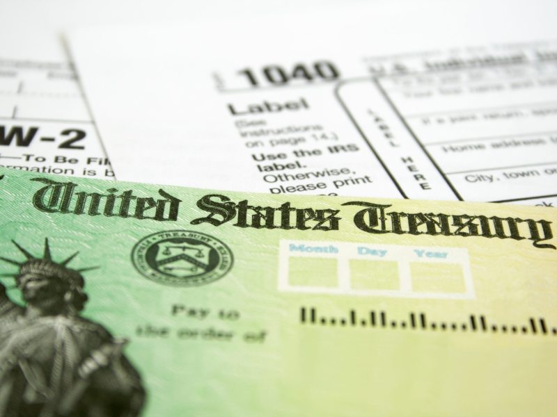 Tax Refund Check with W-2 and 1040 U.S. Individual Income Tax Return Forms