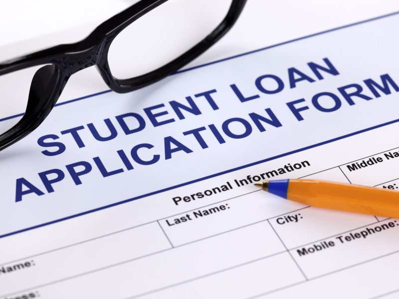 Student Loan Application form with glasses and ballpoint pen